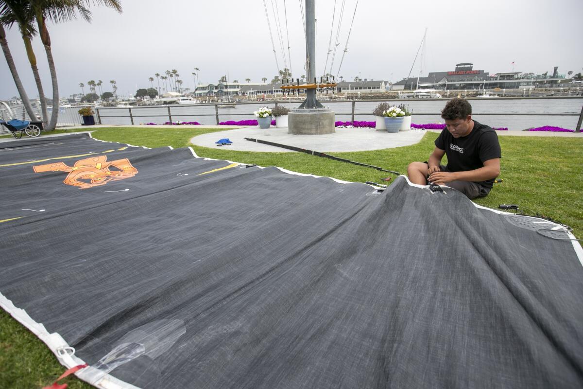 Peter Sangmeister, 21, works on the main sail on Thursday.