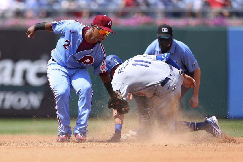 Los Angelas Dodgers' AJ Pollock (11) steals second base before the tag by Philadelphia Phillies second baseman Jean Segura (2) during the fourth inning of a baseball game Thursday, Aug. 12, 2021, in Philadelphia, Pa. (AP Photo/Rich Schultz)