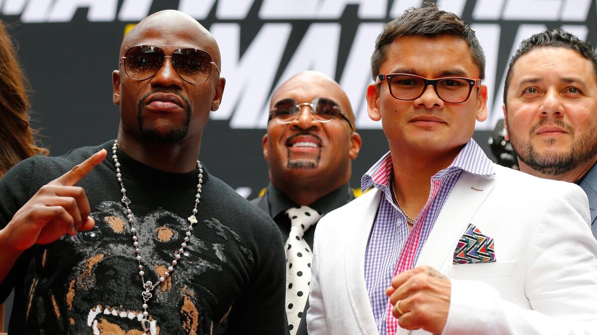 Floyd Mayweather Jr., left, and Marcos Maidana pose for photos during a news conference in New York in July. Maidana is hoping to take a calmer and more measured approach against Mayweather than he did in May.