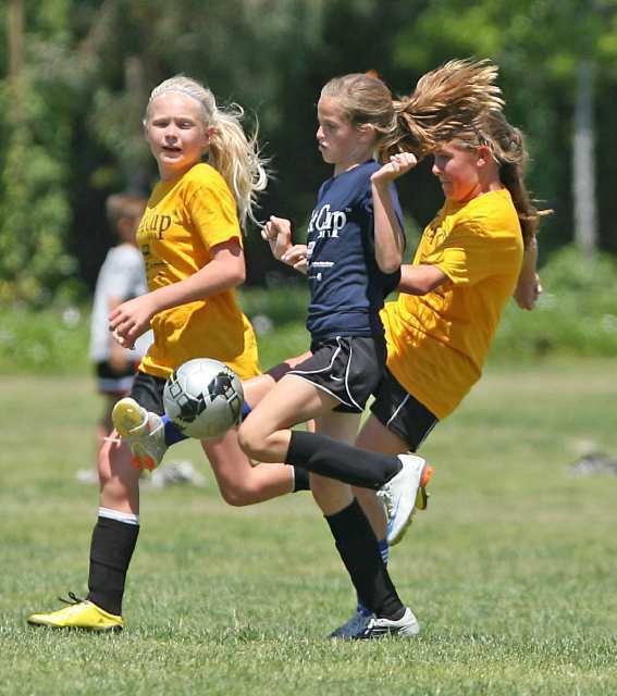 Pegasus Cassidy Brown, middle, dribbles ball downfield surrounded by two Carden Hall defenders in championship game Sunday.