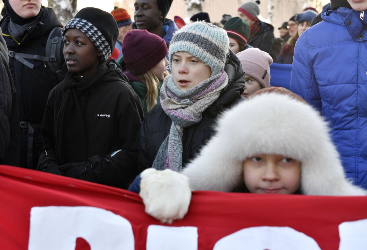 FILE - Swedish climate activist Greta Thunberg, center, takes part in a climate strike with Sami children in Jokkmokk, Sweden, Feb. 7, 2020. Two independent U.N. human rights experts called Thursday Feb. 10, 2022, on Sweden’s government not to issue a license to industrial backers of a planned iron-ore mine that environmentalists say would generate large amounts of toxic waste and other pollution. (Naina Helen Jama/TT News Agency via AP, File)