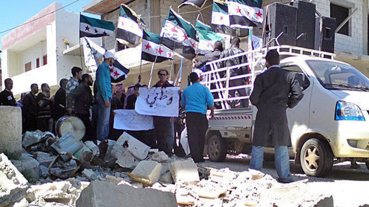 People in Qusair take part in a protest against Syrian President Bashar Assad.