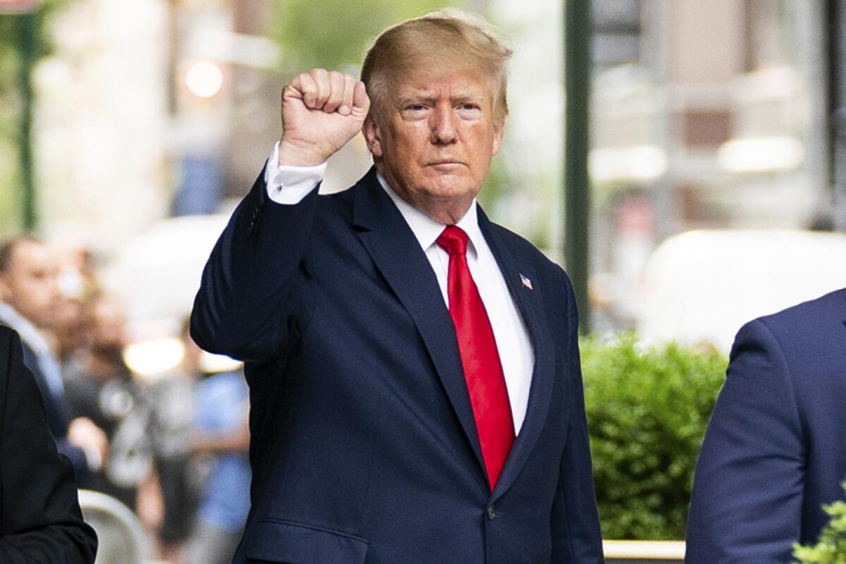 Former President Trump with his fist raised.