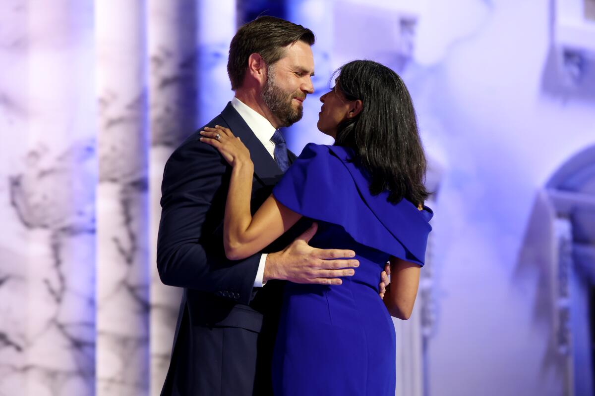 Sen. J.D. Vance hugs his wife, Usha, as he arrives to speak during the Republican National Convention. 