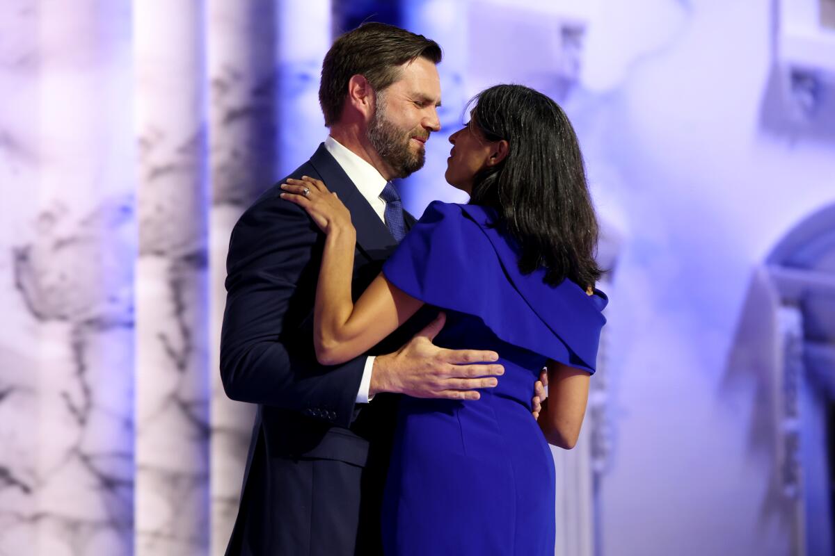 Sen. J.D. Vance hugs his wife, Usha, as he arrives to speak during the Republican National Convention.