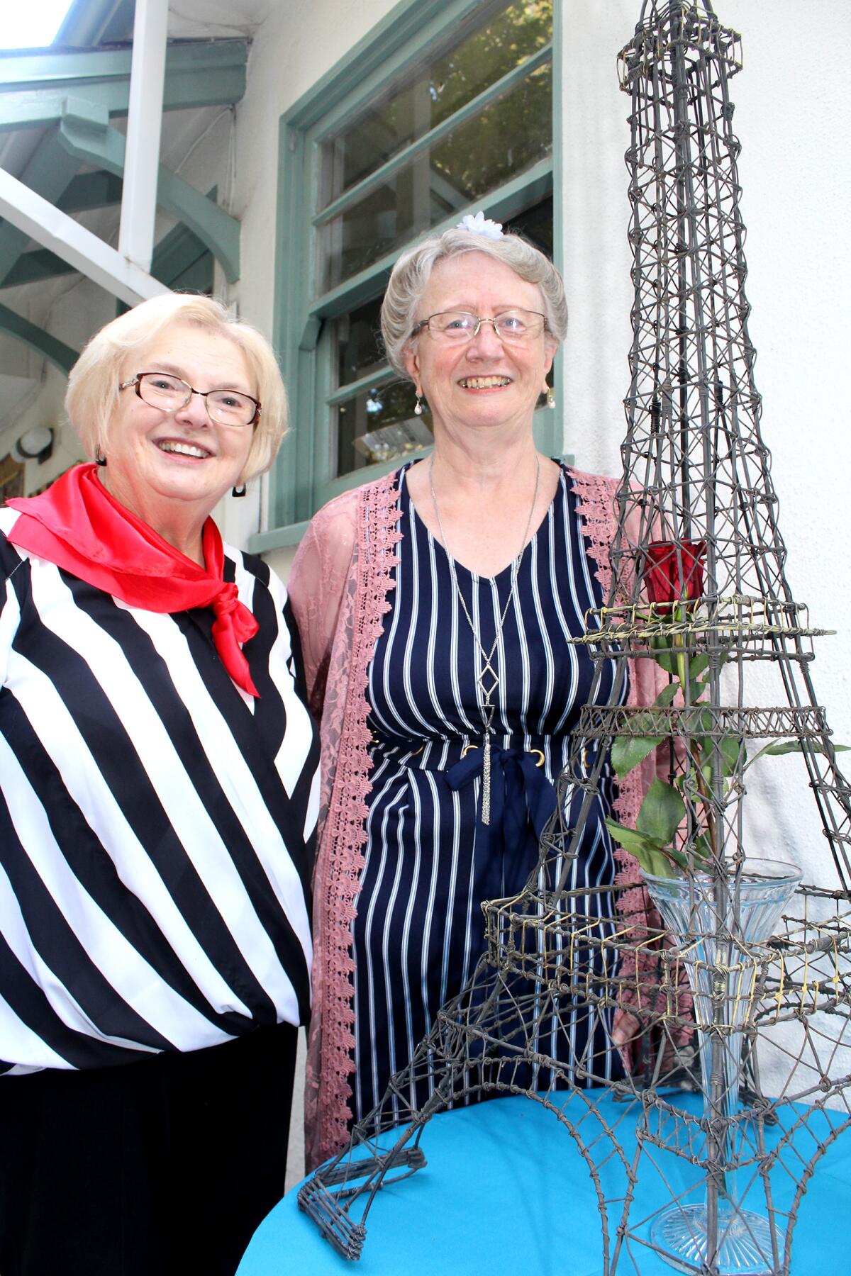 Altrusa’s own Eiffel Tower is graced by member Pat Zayas, left, and Barbara Crawford, Altrusa president.