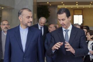 In this photo released by the Syrian official news agency SANA, shows Syrian President Bashar Assad, right, speaks with Iran's Foreign Minister Hossein Amir-Abdollahian on Wednesday, March 23, 2022 in Damascus, Syria. (SANA via AP)