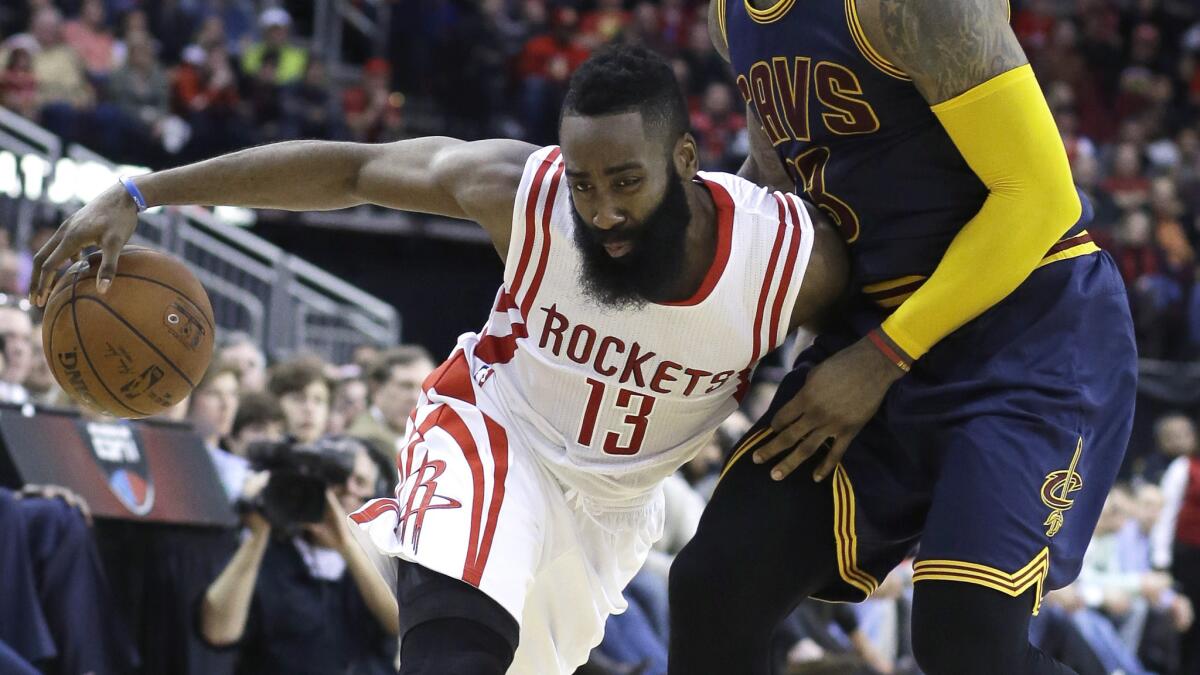 Houston guard James Harden drives on Cleveland Cavaliers forward LeBron James during the Rockets' 105-103 win Sunday.