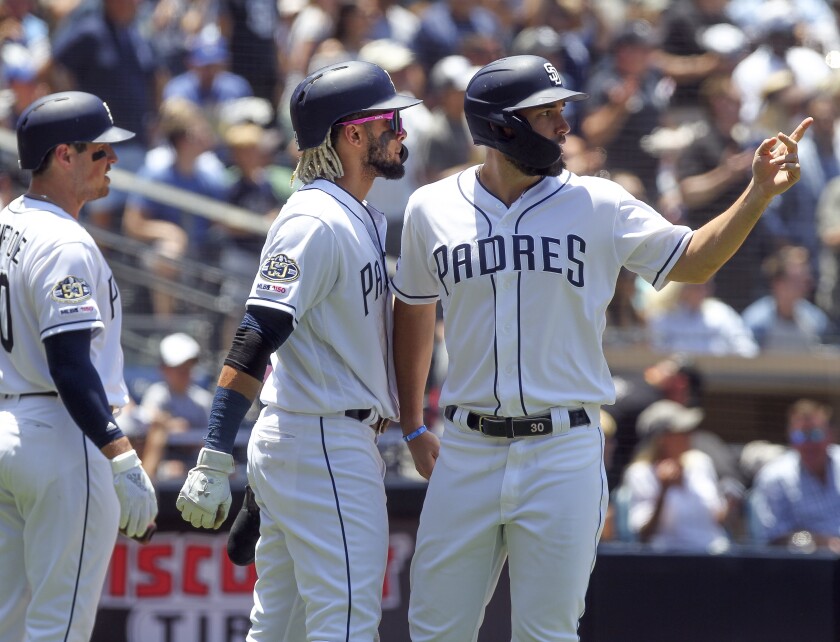 Eric Hosmer, right, is among the small group of Padres veterans who has made it a priority to point the way to winning for the youngest team in the majors.