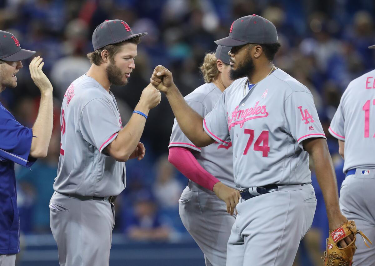Closer Kenley Jansen (74) celebrates a Dodgers victory with pitcher Clayton Kershaw after a game against the Blue Jays on May 8.