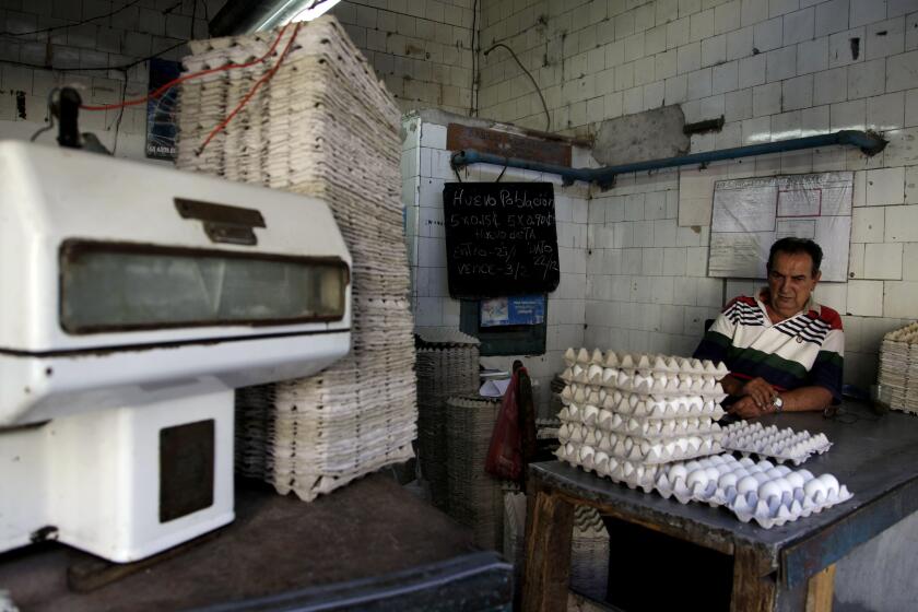 A worker waits for clients at a government store that sells eggs in Old Havana, Cuba, Wednesday Feb. 1, 2012. A report from Cuba's National Statistics office says food prices rose 20 percent last year. (AP Photo/Javier Galeano)