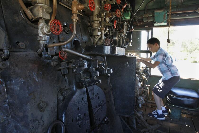 Benjamin Garza, 9, of Calabasas sits inside the cab of Union Pacific's No. 4014. The train is being converted from burning coal to using fuel oil and is being restored as a traveling museum.