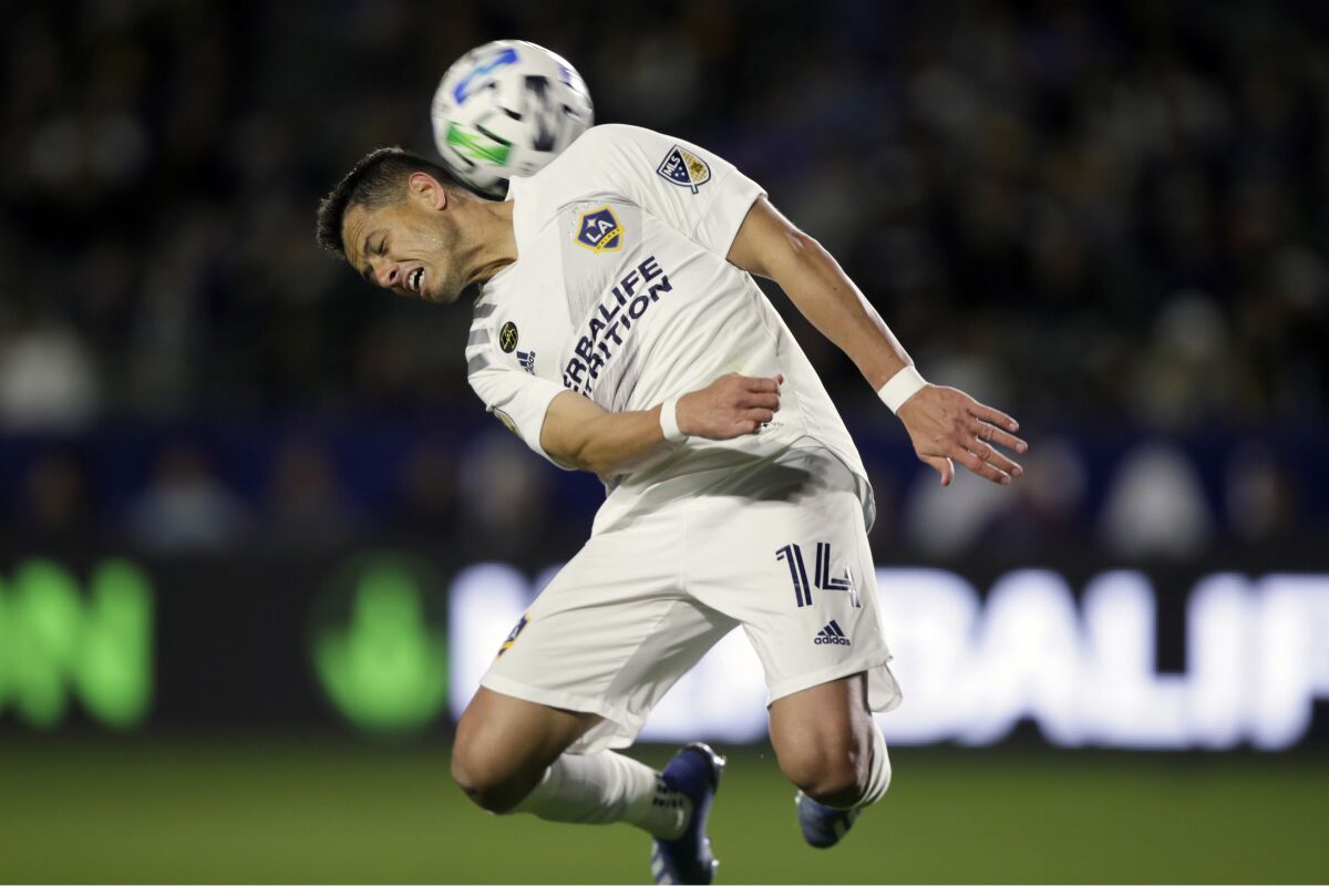 Galaxy forward Javier "Chicharito" Hernandez heads the ball behind him.