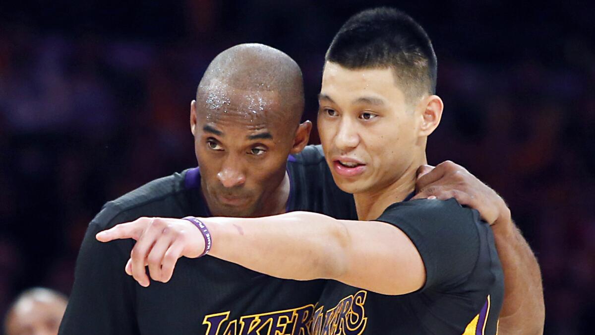 Lakers star Kobe Bryant, left, listens to teammate Jeremy Lin during a loss to the Clippers on Friday.