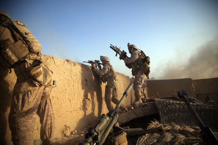 JULY 15, 2012, HELMAND PROVINCE, AFGHANISTAN |Marines from the 2nd Battalion 5th Marine Regiment return fire on the enemy after the enemy fired an RPG rocket at their position. It was the longest firefight for the Marines in Afghanistan during the war, stretching more than 48 hours, exchanging machine gun fire, mortars and RPGs. (Nelvin C. Cepeda / The San Diego Union-Tribune)