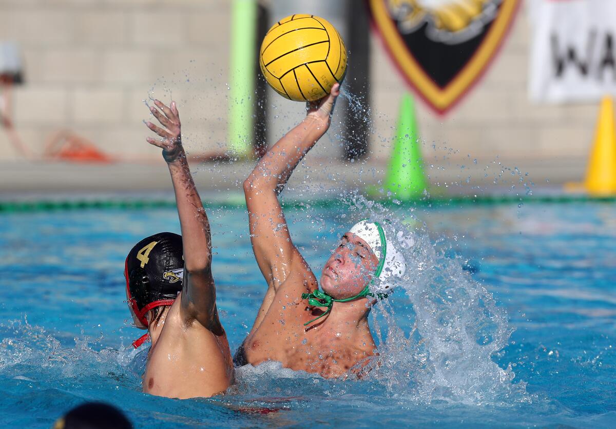 Costa Mesa's Wes Brazda, right, scores against Estancia's Mateo Evans, left, during the first half of Wednesday's match.