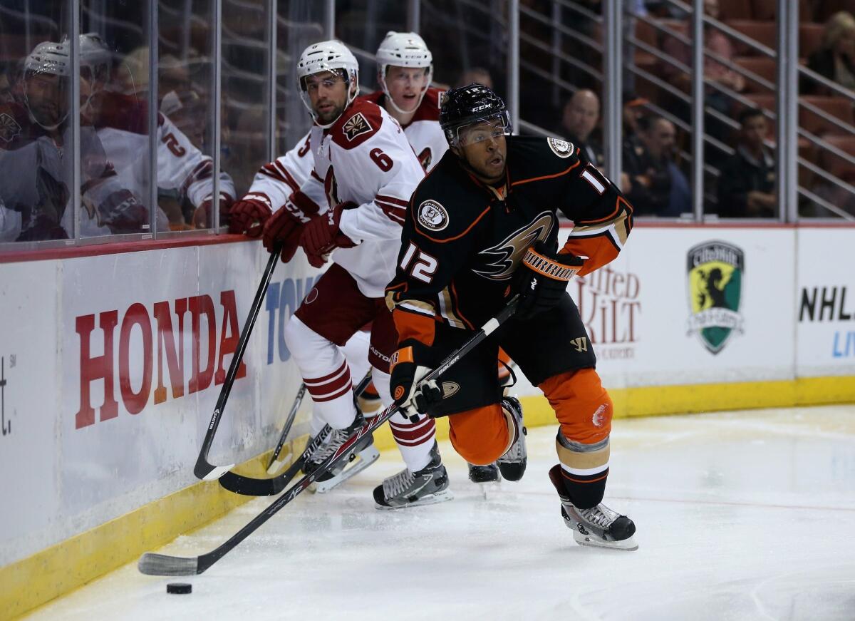 Anaheim's Devante Smith-Pelly skates with the puck as Arizona's David Schlemko (6) pursues in the first period of a game Tuesday at Honda Center.