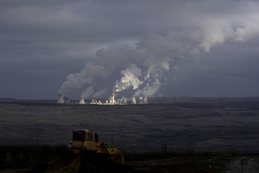 Smoke rises from chimneys of Turow power plant located by the Turow lignite coal mine near the town of Bogatynia, Poland, Saturday, Jan. 15, 2022. The Polish lignite mine is located near the Czech border and Czech authorities have said it negatively affects the environment and drains water from local villages. (AP Photo/Petr David Josek)