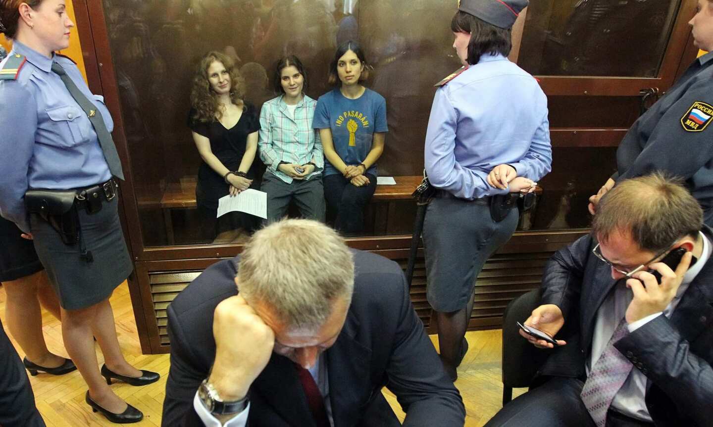 Russian feminist punk-rock band Pussy Riot members Maria Alyokhina, left, Yekaterina Samutsevich and Nadezhda Tolokonnikova sit in a glass-walled cage in a courtroom after the judge delivered the verdict at the Khamovnichesky Court in Moscow. Judge Marina Syrova sentenced the trio, who were found guilty of hooliganism motivated by religious hatred or hostility after singing a song insulting Vladimir Putin in the Christ the Savior Cathedral in Moscow earlier this year ahead of presidential elections in Russia, to two years in prison.