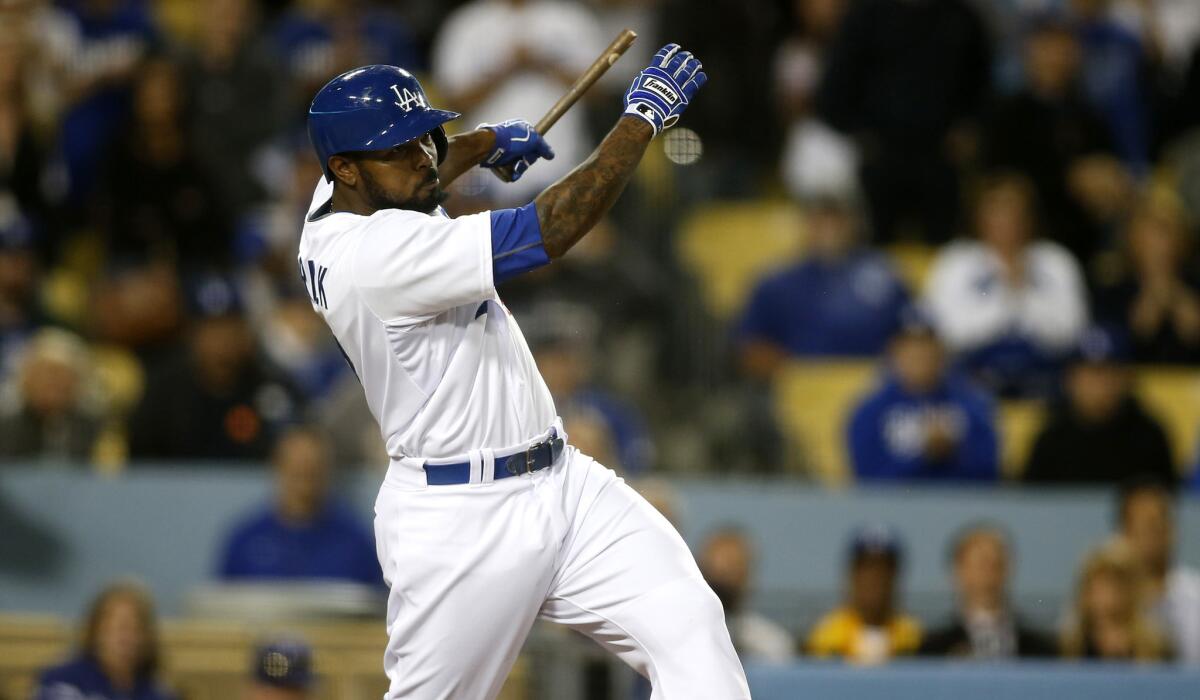 Dodgers second baseman Howie Kendrick breaks his bat while delivering the game-winning hit against Mariners in the ninth inning on Tuesday night at Dodger Stadium.
