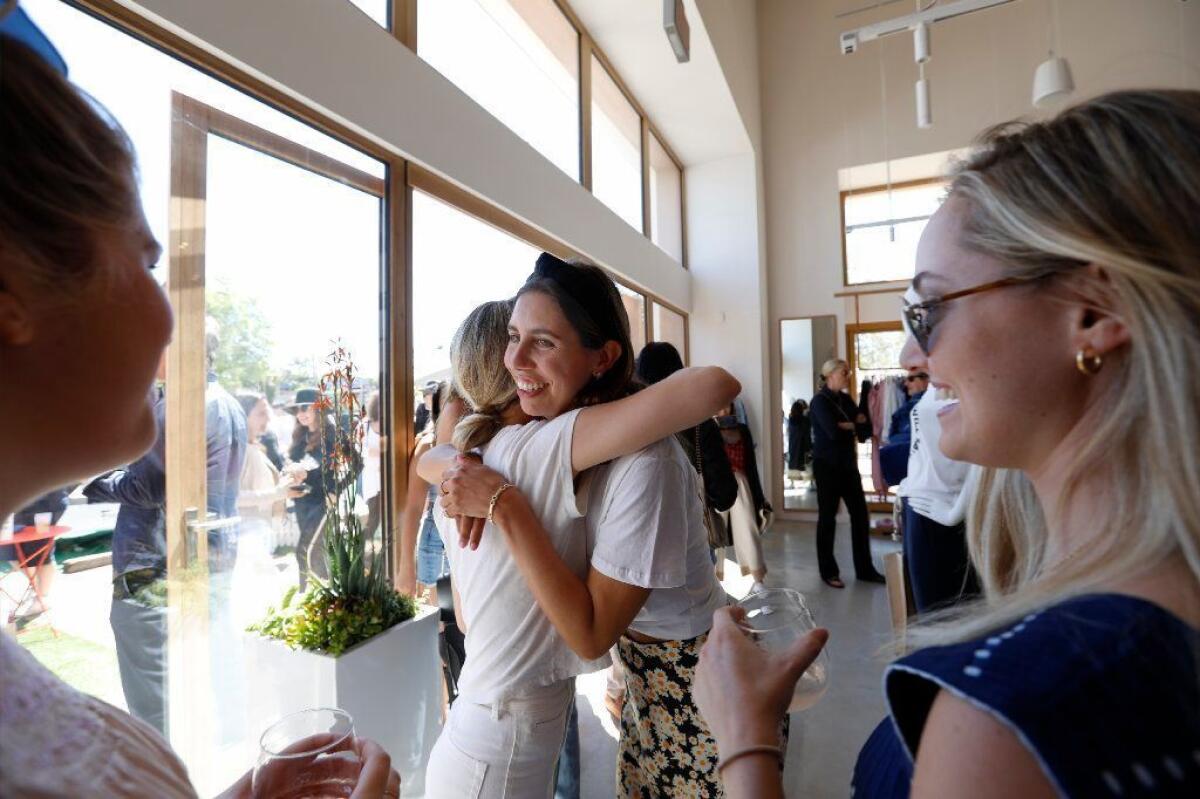 Molly Segal, middle, the brand manager of Maris Collective and Fred Segal's granddaughter, was greeted with hugs during the opening of the Malibu store.