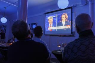 People watch a presidential debate between Republican presidential nominee former President Donald Trump and Democratic presidential nominee Vice President Kamala Harris at a watch party hosted by the Alice B. Toklas LGBTQ Democratic Club at the Academy on Tuesday, Sept. 10, 2024, in San Francisco. (AP Photo/Juliana Yamada)