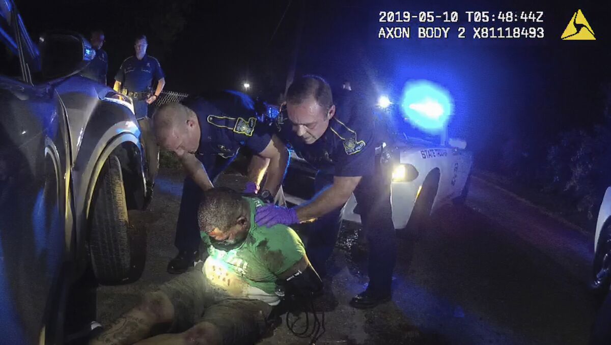 FILE - This file image from Louisiana State Police Trooper Dakota DeMoss' body-worn camera video shows other troopers holding up Ronald Greene before paramedics arrived on May 10, 2019, outside of Monroe, La. A reexamined autopsy ordered up by the FBI in the deadly arrest of Greene has rejected the Louisiana State Police claim that a car crash caused his fatal injuries, narrowing prosecutors’ focus on the troopers seen on body camera video beating, stunning and dragging him. (Louisiana State Police via AP, File)