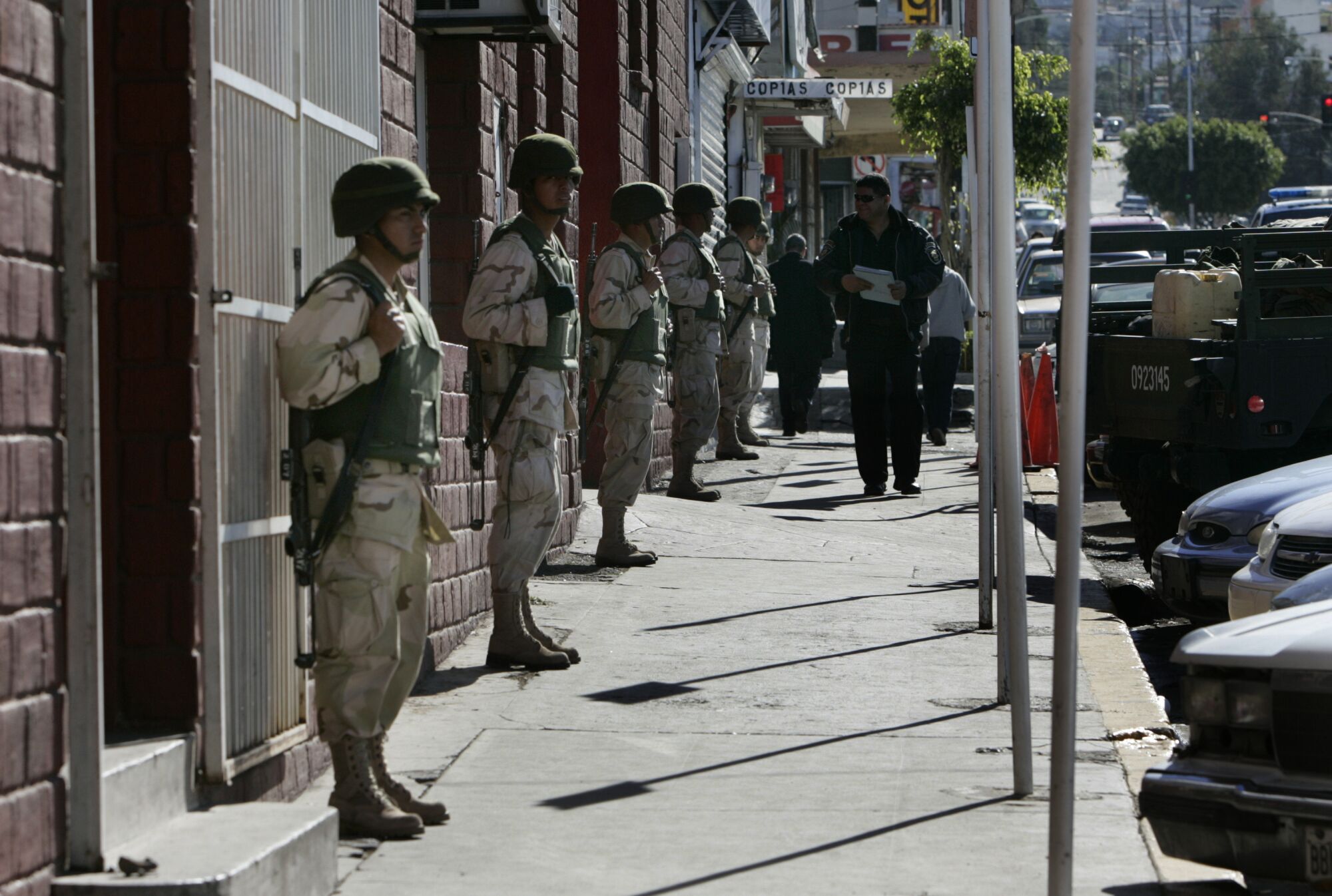 Soldiers stand guard outside Tijuana's police station, where guns confiscated from municipal police officers were stored.