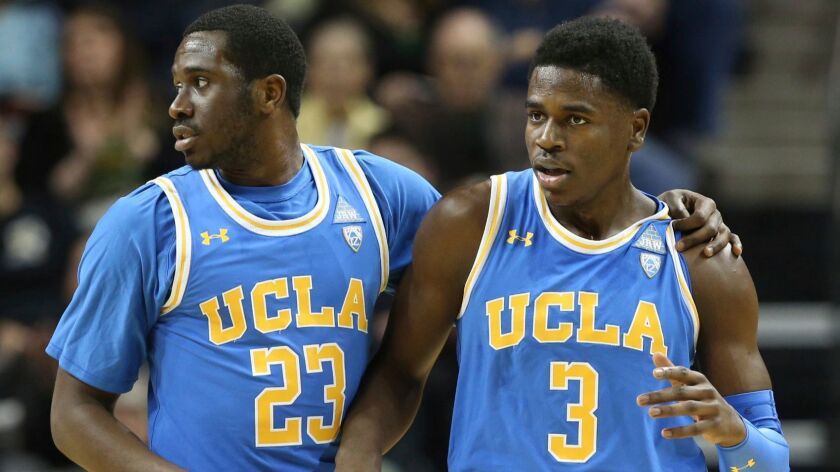 UCLA'S Prince Ali, left, consoles Aaron Holiday after he was called for a foul against Oregon on Jan. 20.