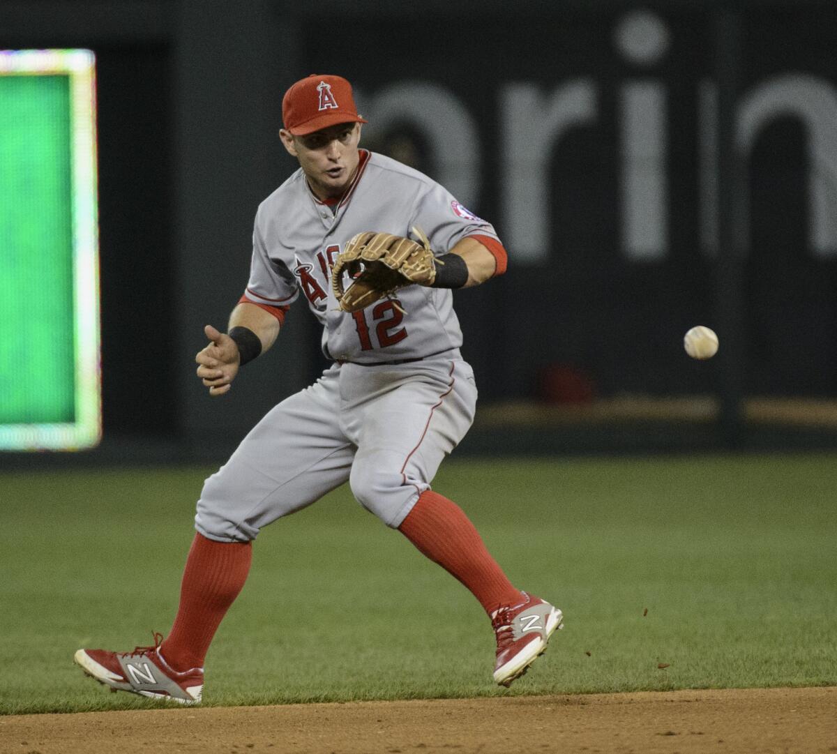 Angels second baseman Johnny Giavotella reaches for a grounder during a game against the Kansas City Royals on Aug. 14.
