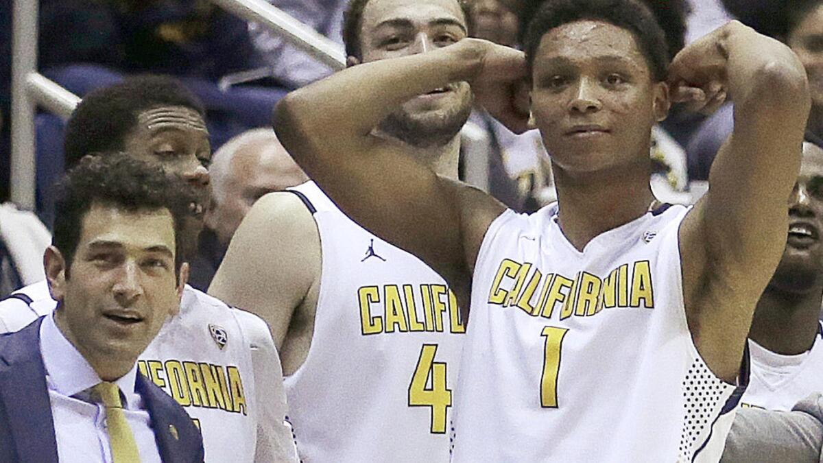 UC Berkeley assistant basketball coach Yann Hufnagel, left, is shown with players during an NCAA college basketball game against Oregon on Feb. 11. School officials announced Monday that Hufnagel had been relieved of his duties in connection with sex harassment allegations.