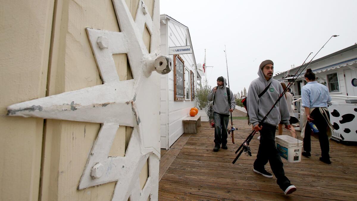 Fishermen walk on the pier in Malibu, which last week became a sanctuary city.