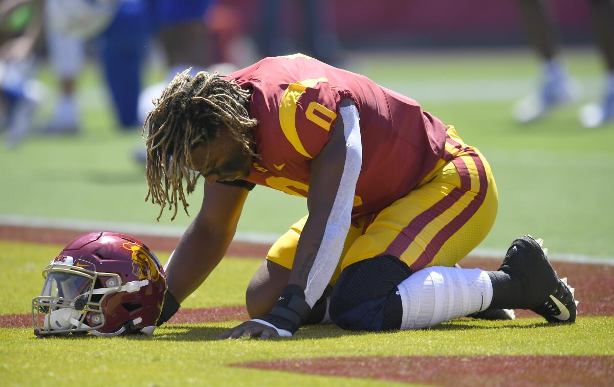 USC Trojans defensive lineman Korey Foreman kneels in the end zone before a game against San Jose State last season.