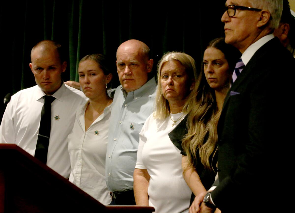 Family members stand next to District Attorney George Gascon