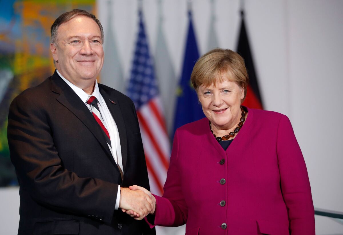 Then-Secretary of State Michael R. Pompeo shaking hands with then-German Chancellor Angela Merkel