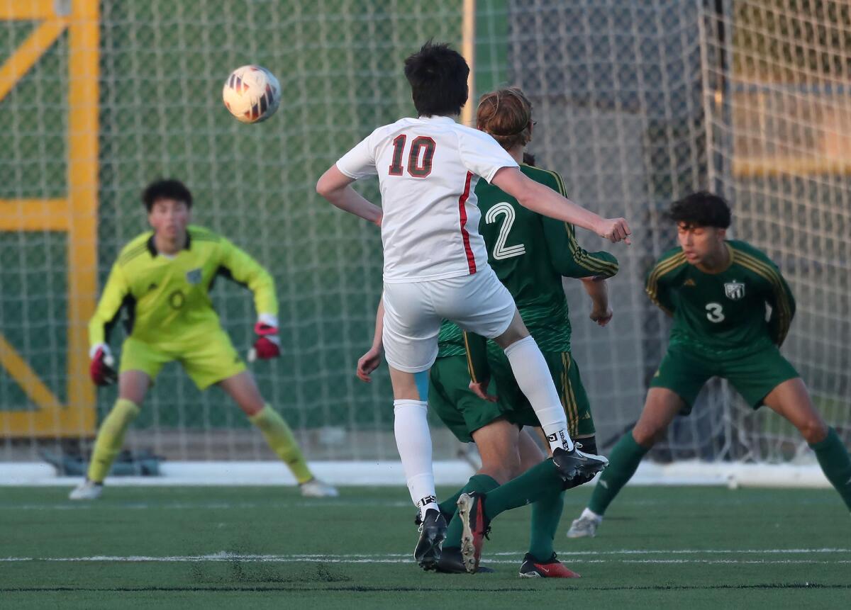 Harvard-Westlake striker Micah Rossen (10) makes a long kick for a goal as goalie Dylan Dwight reacts in the net on Friday.