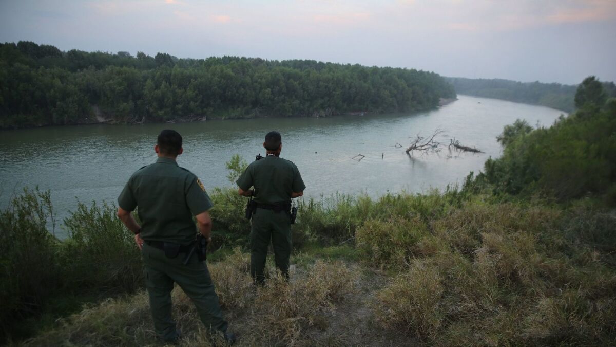 Two Border Patrol agents survey the Rio Grande in 2014. Disheartened, Cantú left the Border Patrol in 2012.