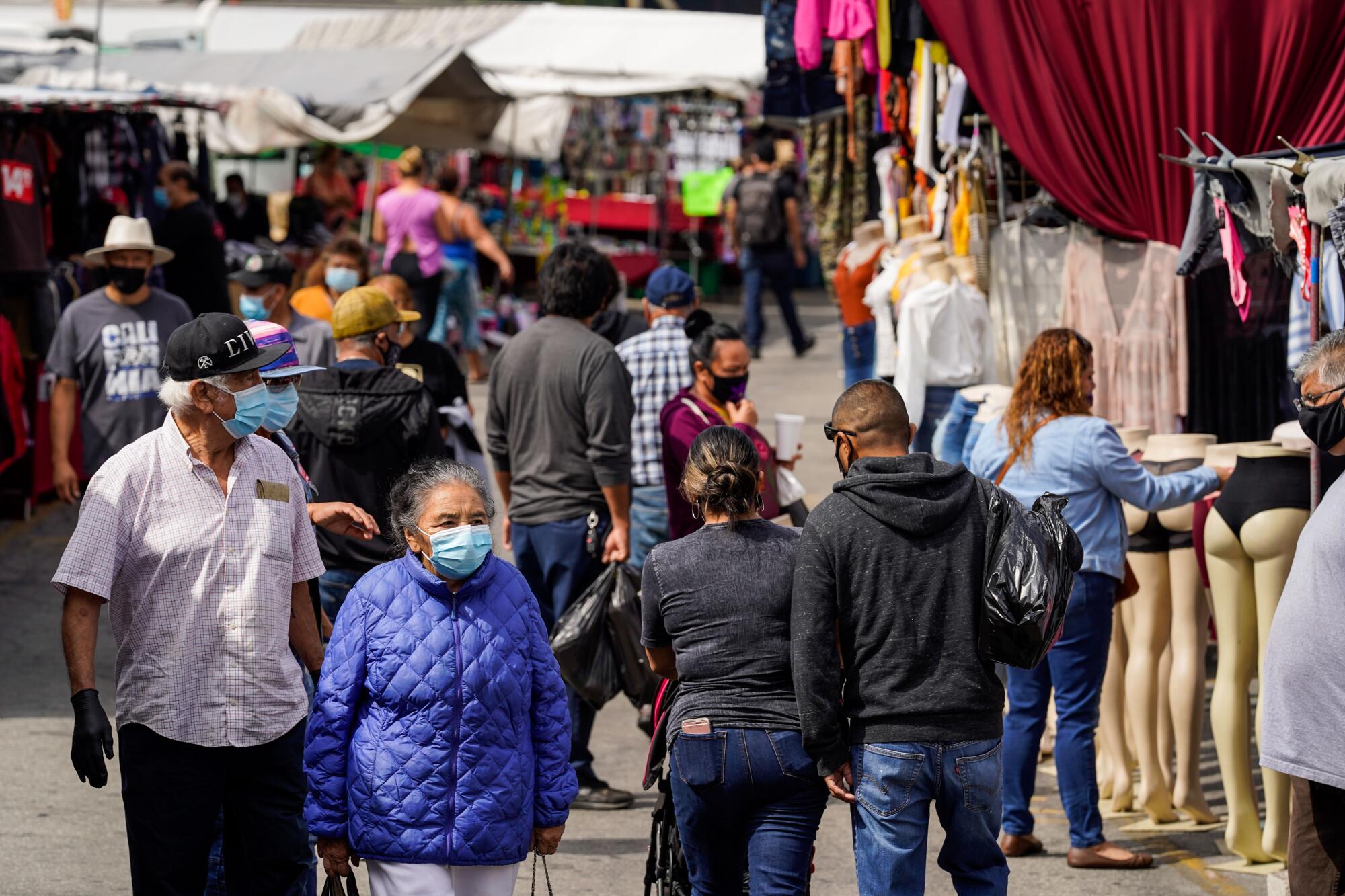 People going to the Santa Fe Springs Swap Meet are required to wear masks and maintain proper social distancing.
