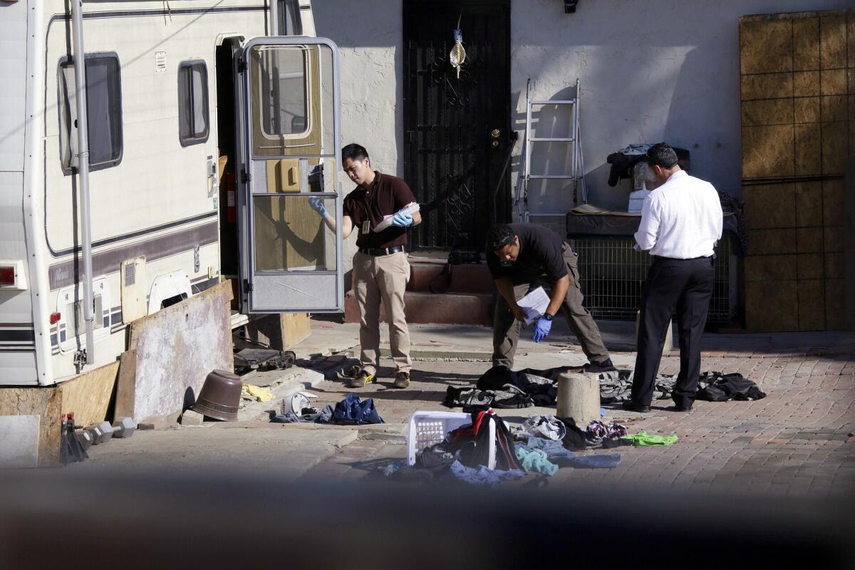 Investigators collect evidence in South Los Angeles where a 6-year-old boy was stabbed to death in the 1600 block of East 88th Street.