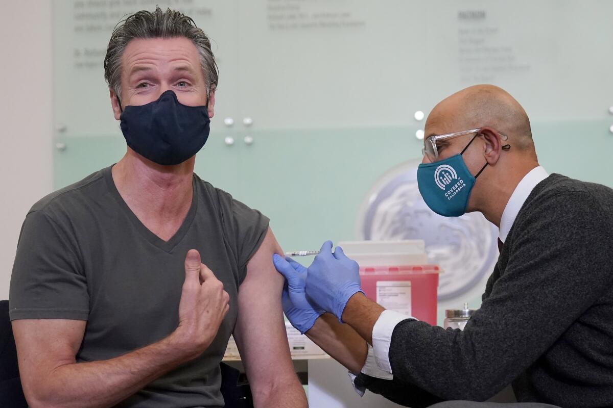 California Gov. Gavin Newsom receives a Moderna COVID-19 vaccine booster shot.