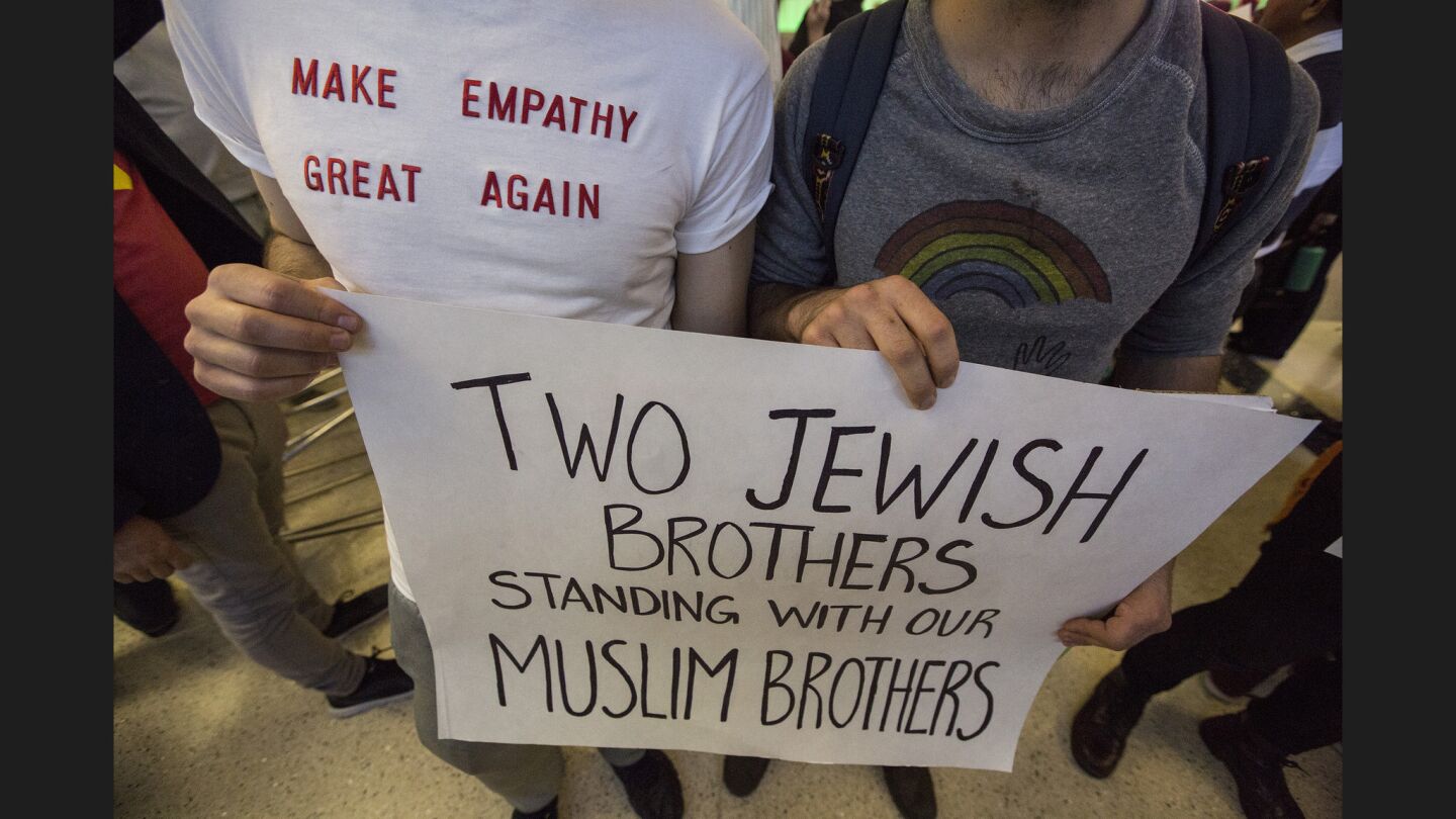 Brothers Adam, left, and Noah Reich show their support of immigrants as they join opponents of Donald Trump's new immigration order at the Tom Bradley International Terminal.