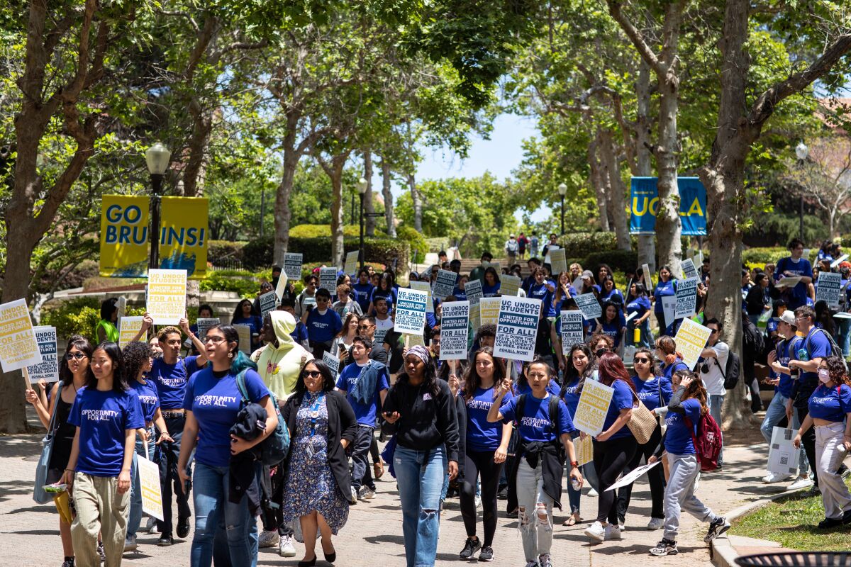 Students and supporters rally to support students without legal status in the University of California system.