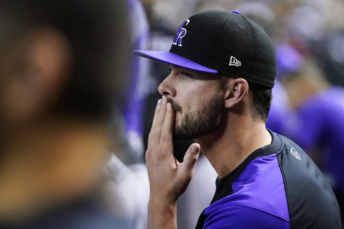 Colorado Rockies' Kris Bryant watches his teammates on the field from the dugout during the ninth inning of a baseball game against the Arizona Diamondbacks on Friday, May 6, 2022, in Phoenix. The Diamondbacks won 4-1. (AP Photo/Ross D. Franklin)