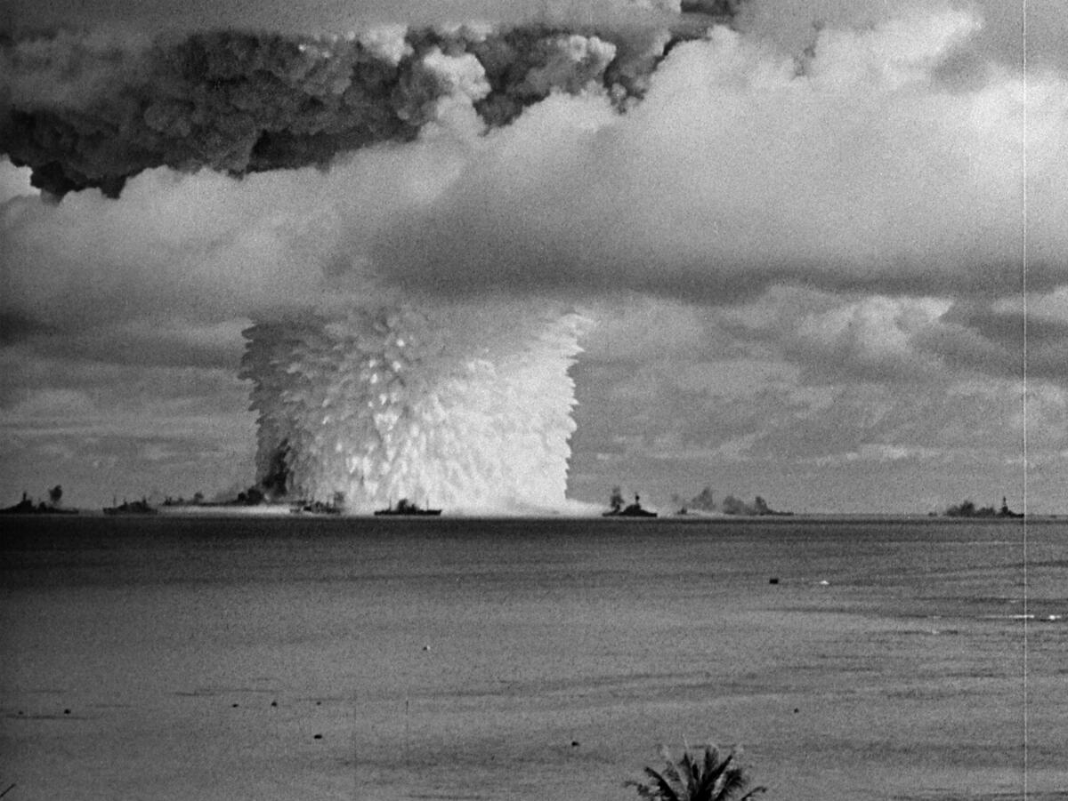 A black-and-white image of a mushroom cloud.