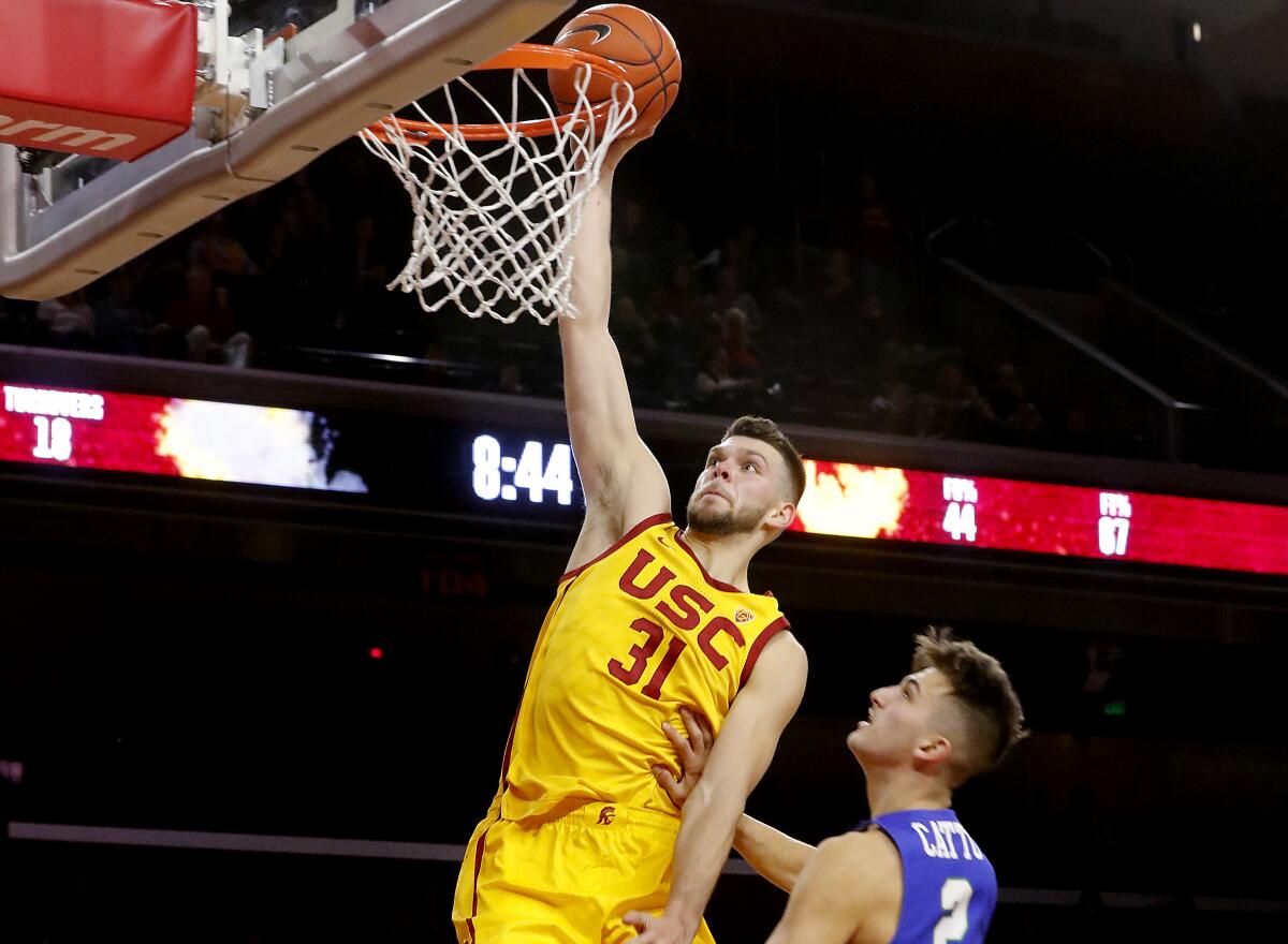 USC forward Nick Rakocevic dunks over Florida Gulf Coast guard Caleb Catto.