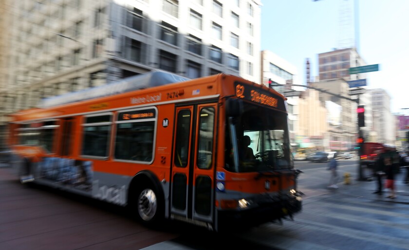 A bus motors down 3rd Street in downtown Los Angeles. As of Sunday, social distancing measures are in place on MTA's buses.