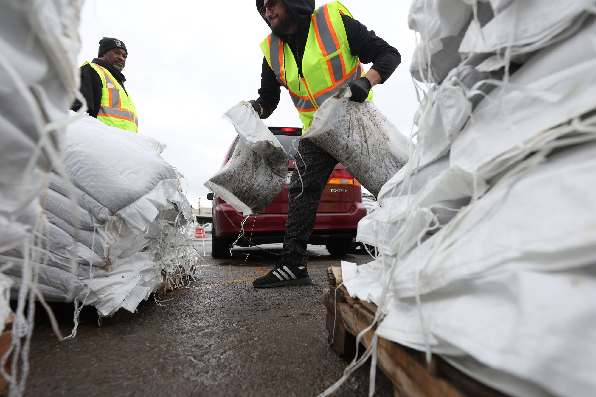 San Francisco city workers load sandbags into a car