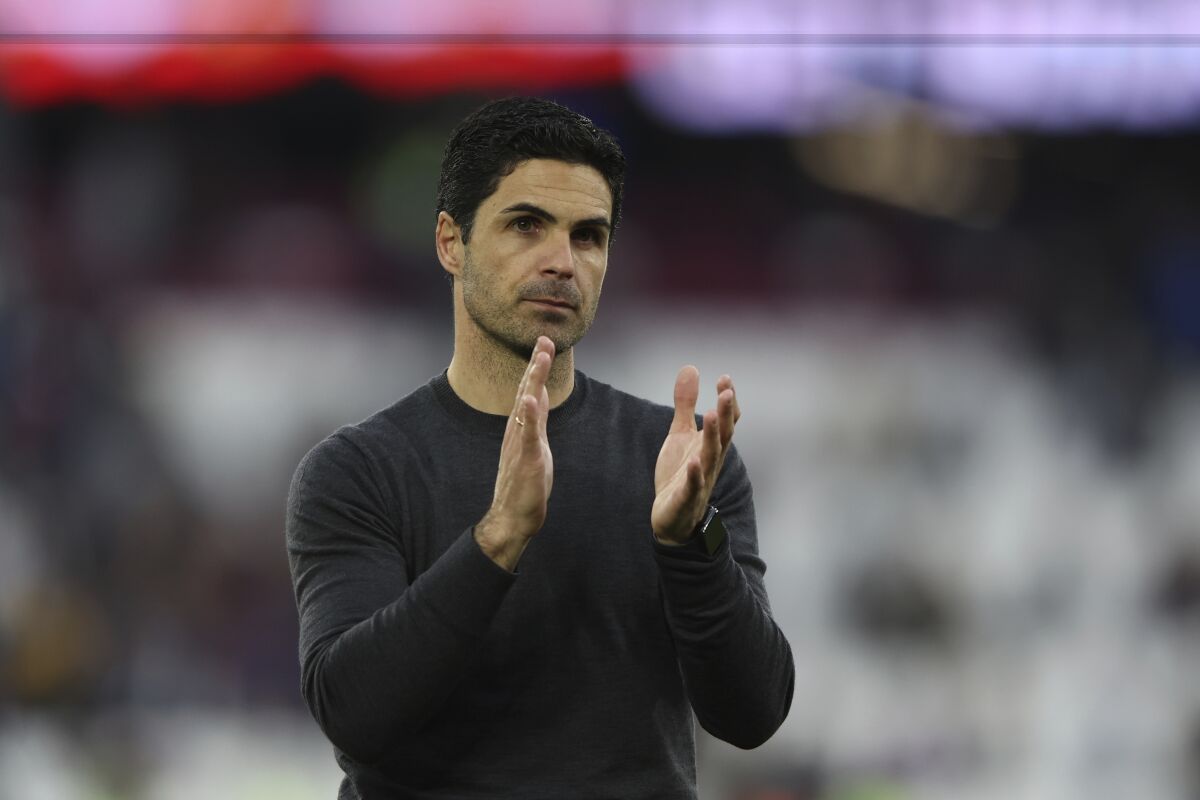 Arsenal's manager Mikel Arteta applauds his teams fans after the end of the English Premier League soccer match between West Ham United and Arsenal at the London stadium in London, Sunday, May 1, 2022. Arsenal win the game 2-1. (AP Photo/Ian Walton)