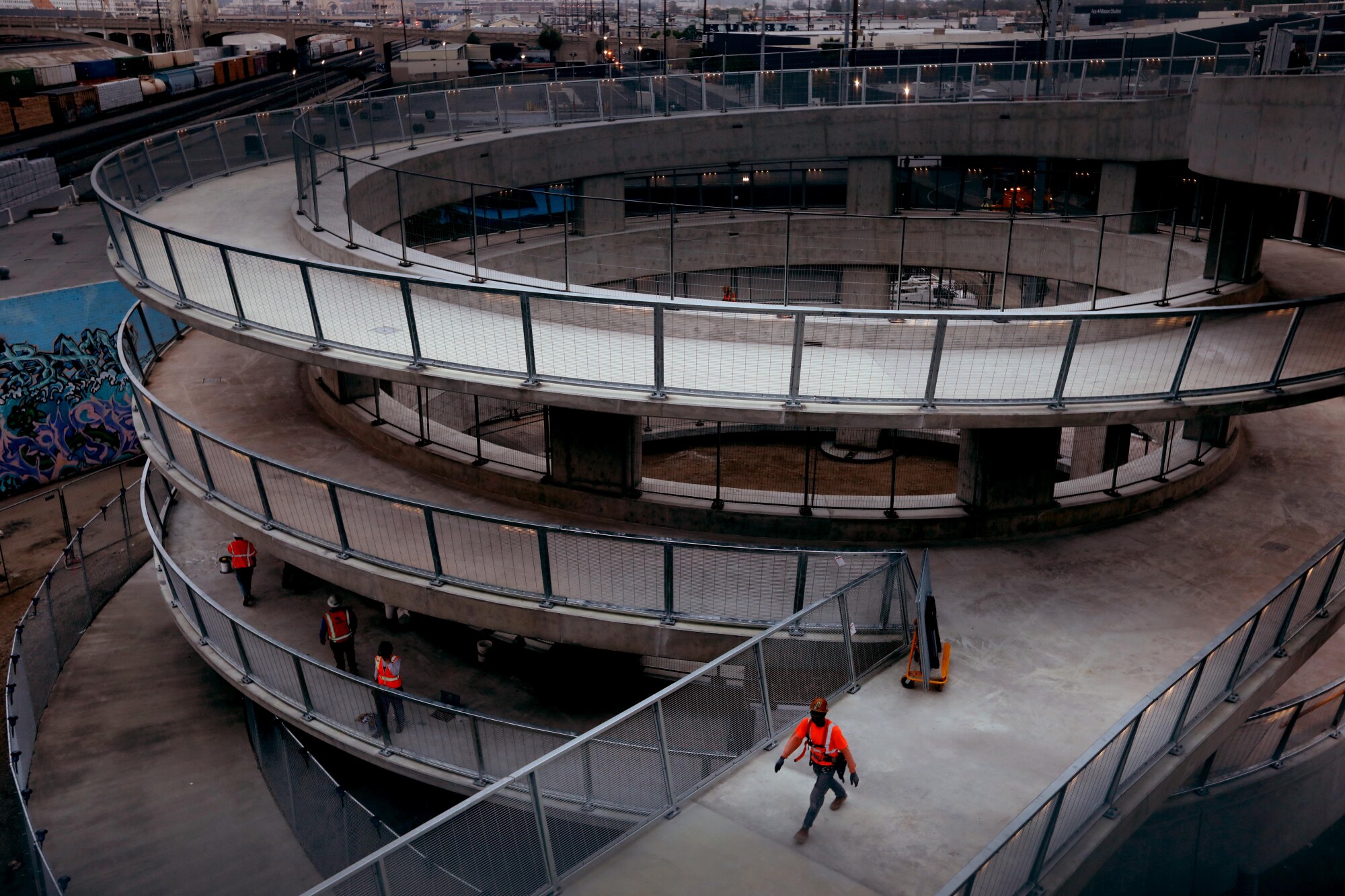Construction workers put the finishing touches on a ramp that serves as a pedestrian walkway to the new 6th Street Viaduct.