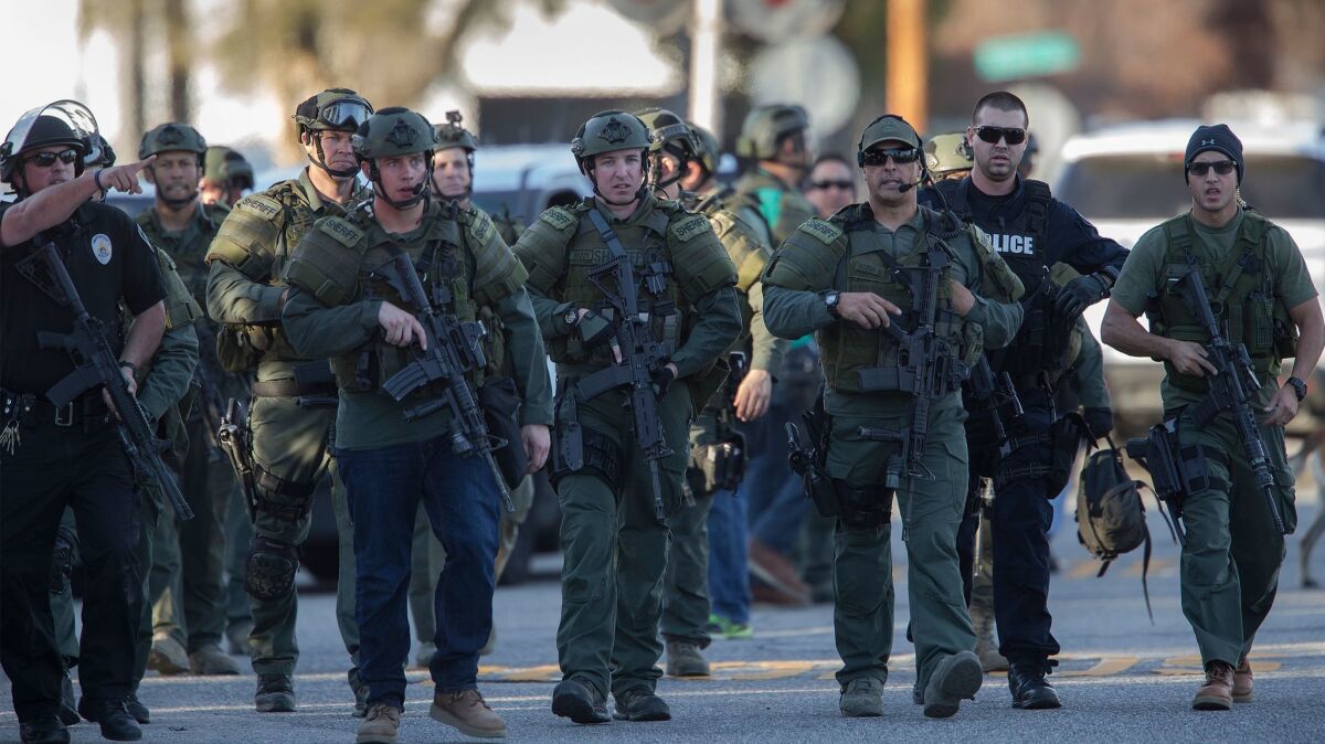 SWAT officers search for suspects involved in the San Bernardino shootings that killed 14 at the Inland Regional Center on Dec. 2, 2015.